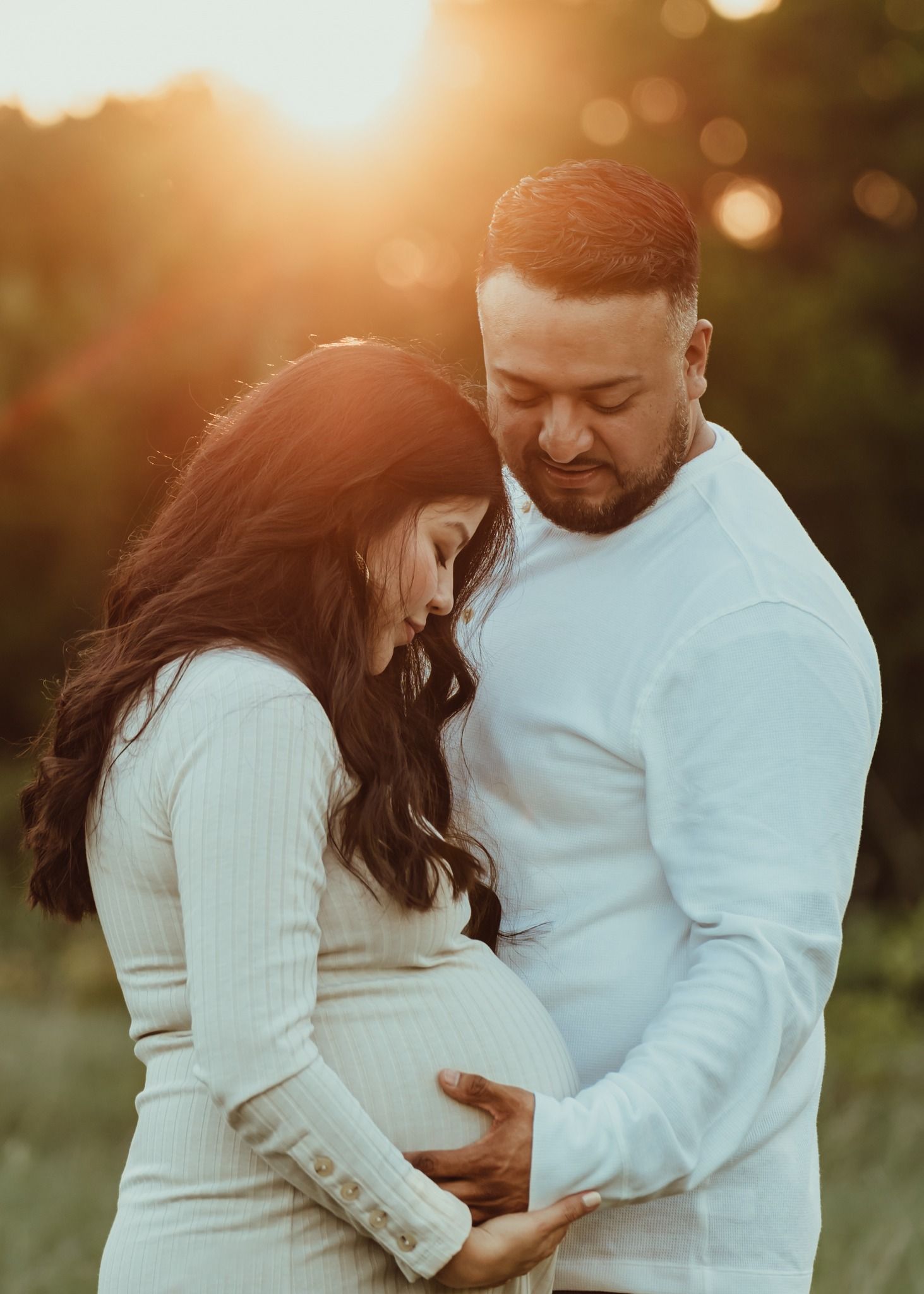 Couple embracing maternity session golden hour Central Texas Sudden Joy Visuals