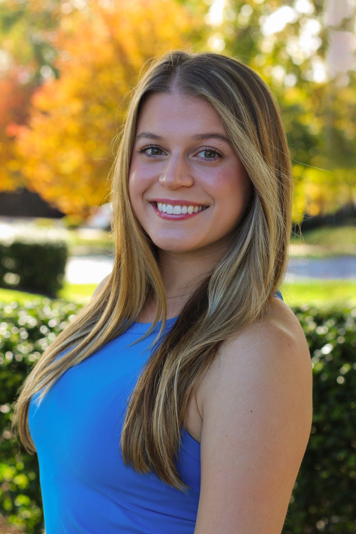 Outdoor portrait series with natural lighting and autumn background.
