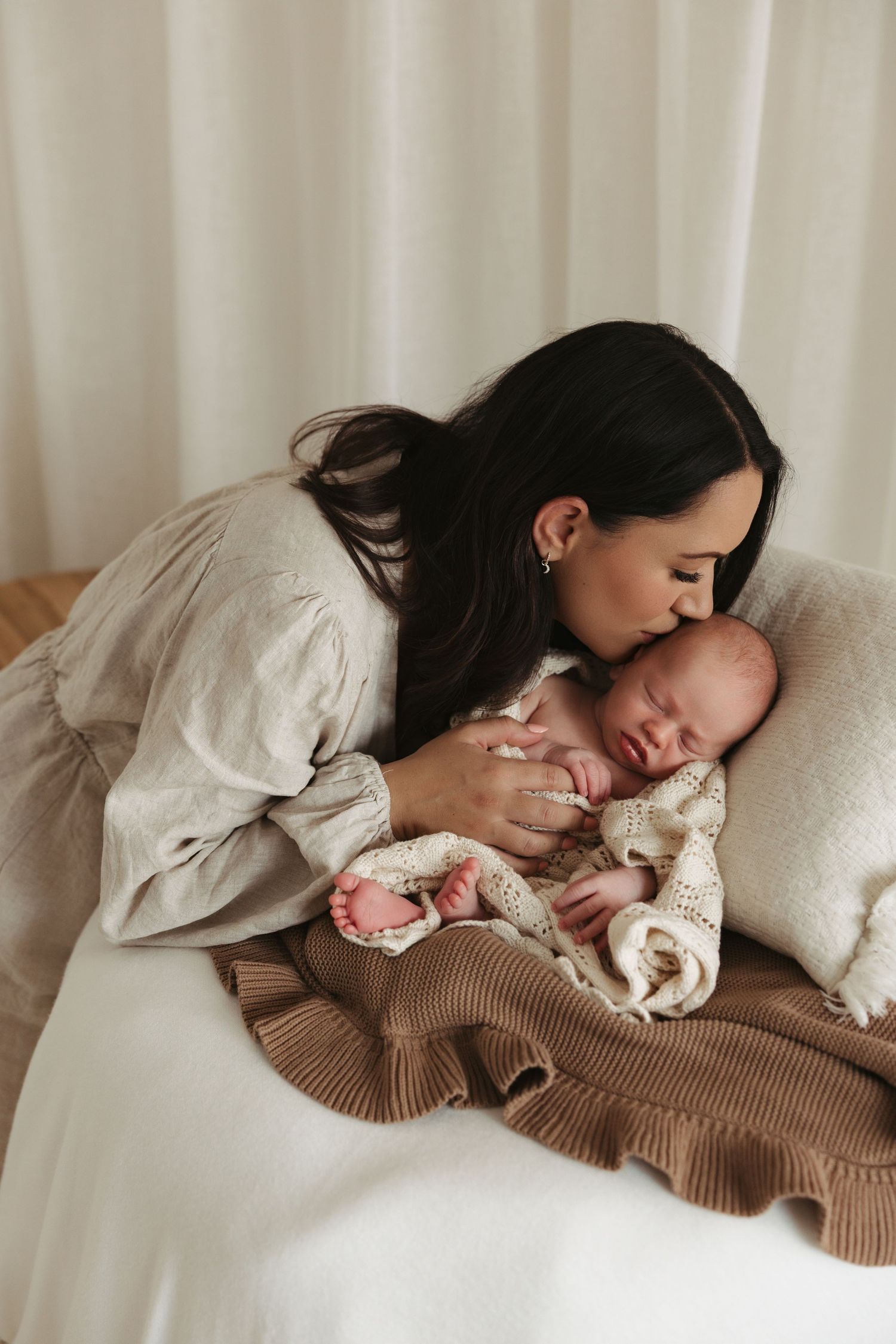 A series of tender moments showing someone snuggling with a small white dog on a cozy bed.