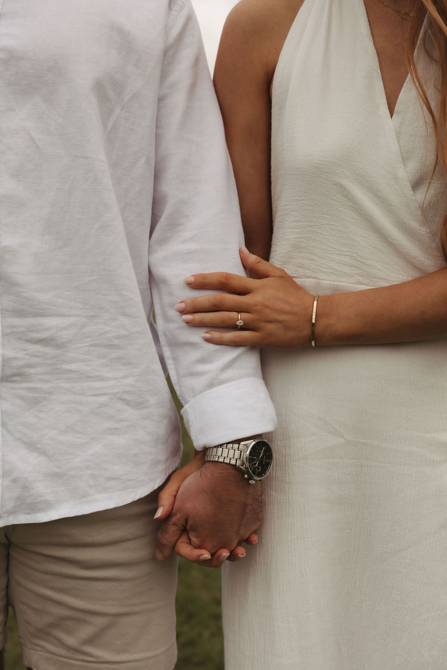 Close-up series of a couple in white and beige wedding attire holding hands and embracing.