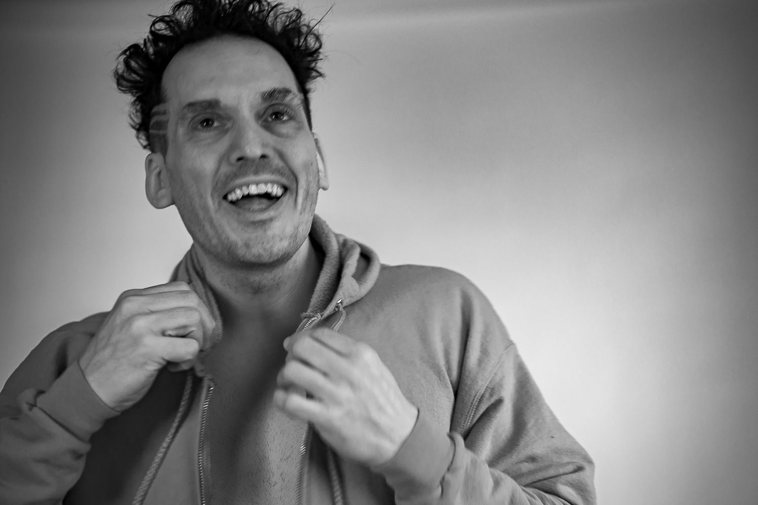 A black and white photo series showing someone in various candid poses and expressions.