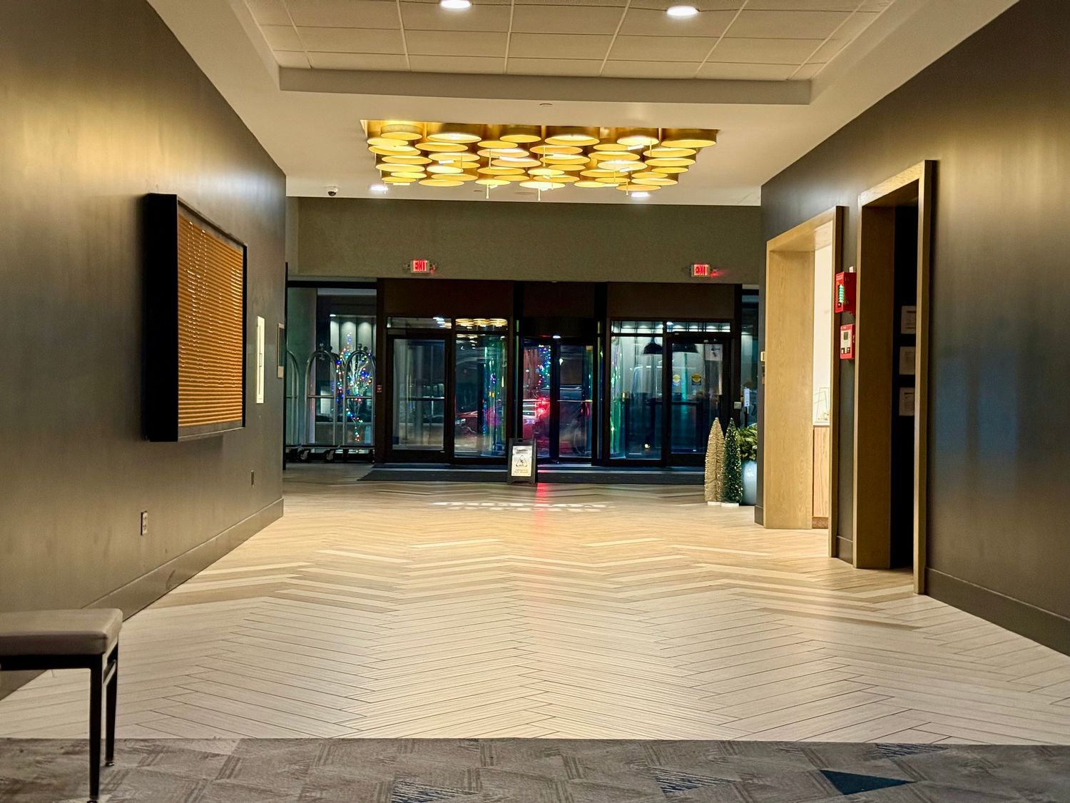 Long empty commercial hallway with recessed lighting and modern architectural features in a business building interior.