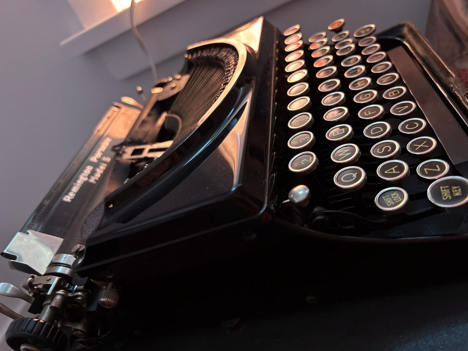 Artistic close-up shots of vintage typewriter keys and mechanisms in dramatic lighting.