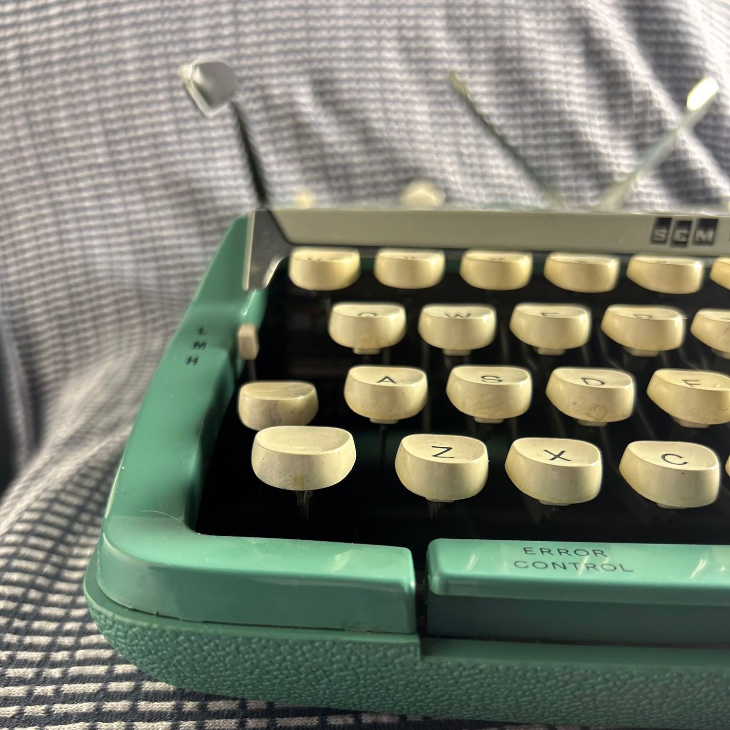 Detail shots of mint green vintage typewriter keys and mechanism.