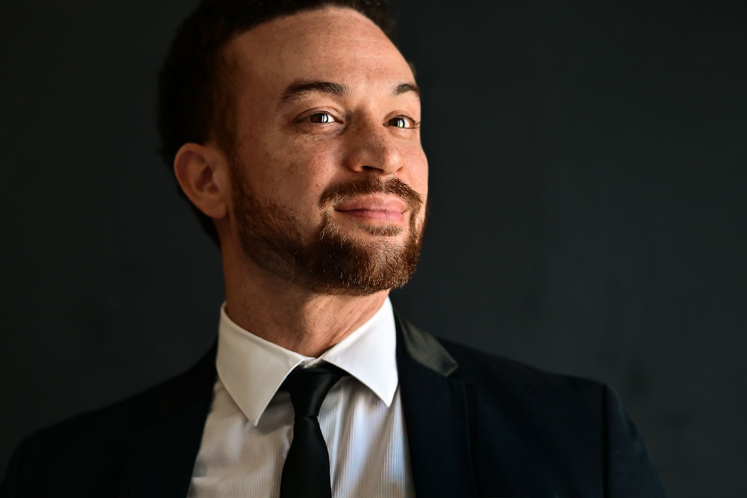 A collection of dramatic headshots against dark backgrounds showing different angles and expressions.