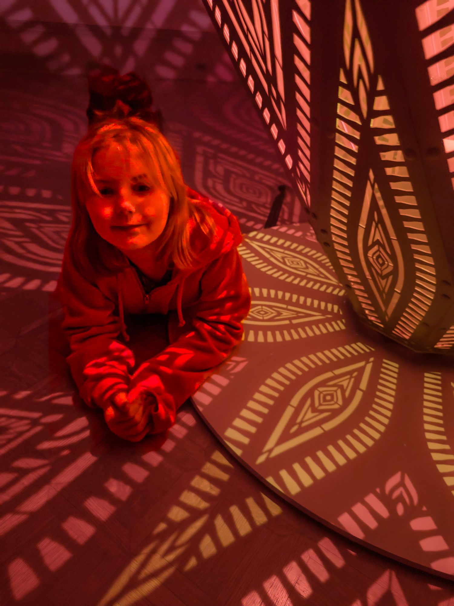 Red-tinted portraits with decorative shadow patterns creating artistic effect.