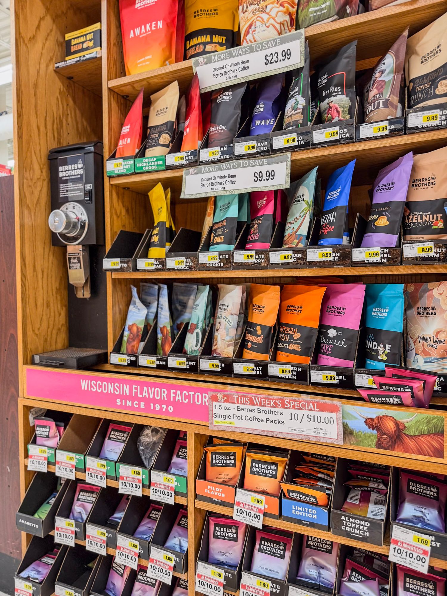 Retail shelf display of colorful coffee bags arranged in neat rows.