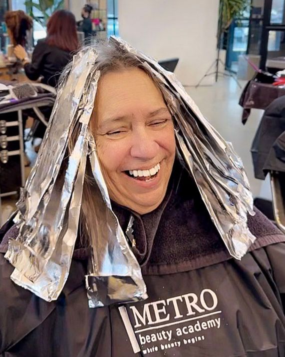 Hair styling session at Metro Beauty Academy with foils being applied.