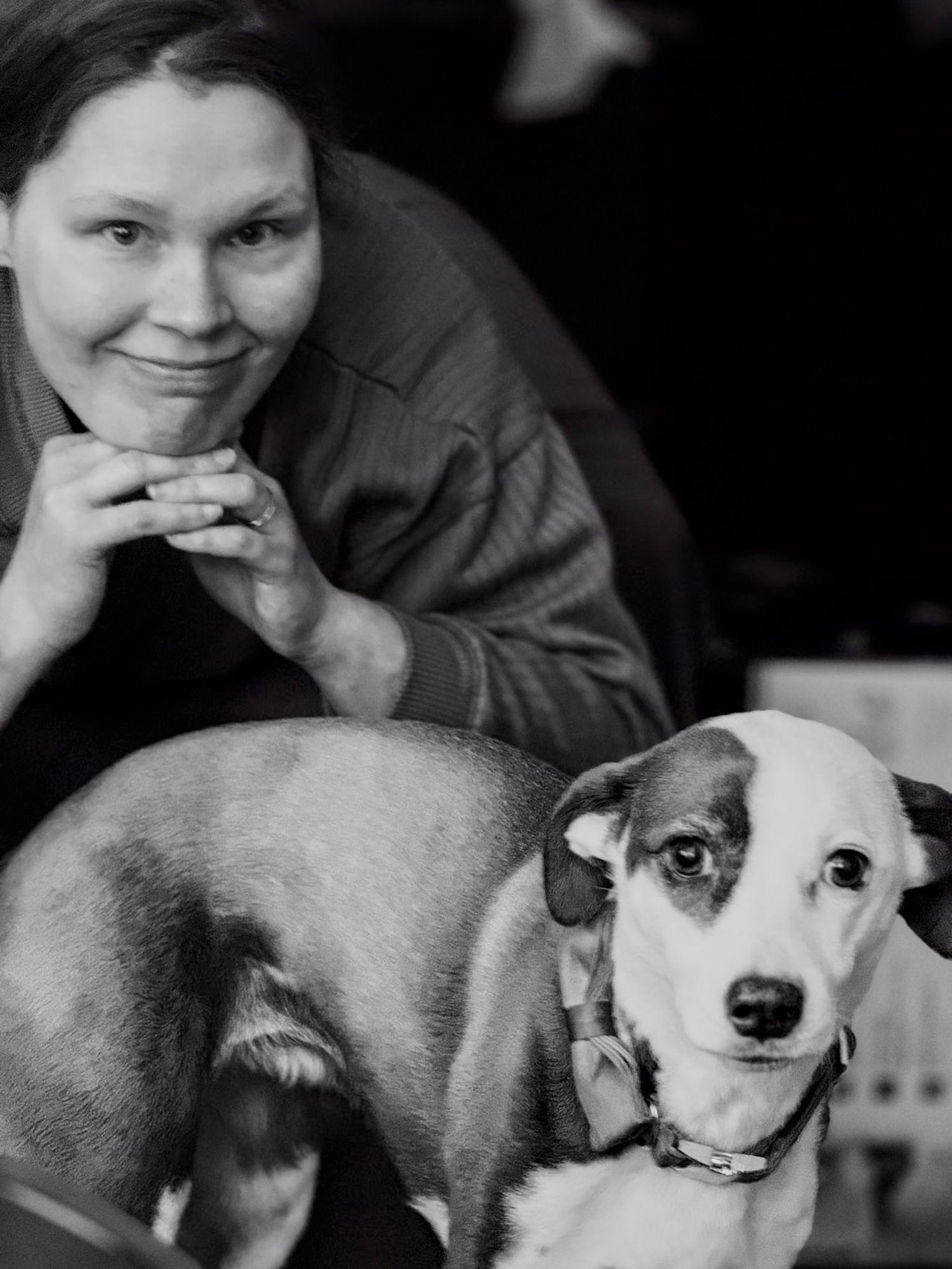Black and white photos showing tender moments with a small white dog.