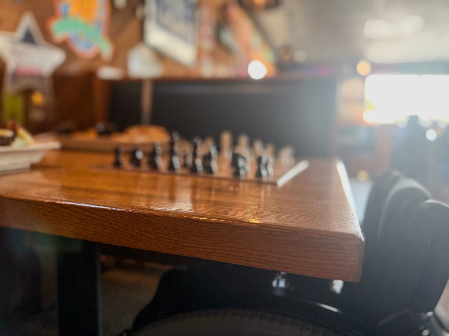 Wooden table surface with blurred background in restaurant setting.