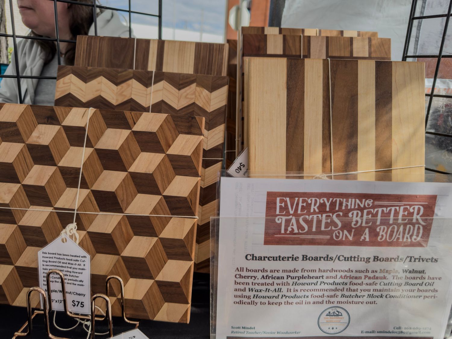Interior wall with geometric brown paneling and signage about tasting menus.