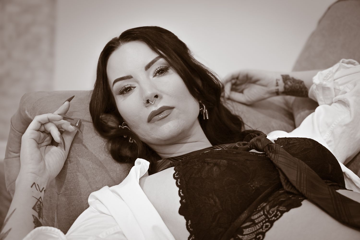 A series of black and white artistic portrait photographs showing dramatic lighting and poses.