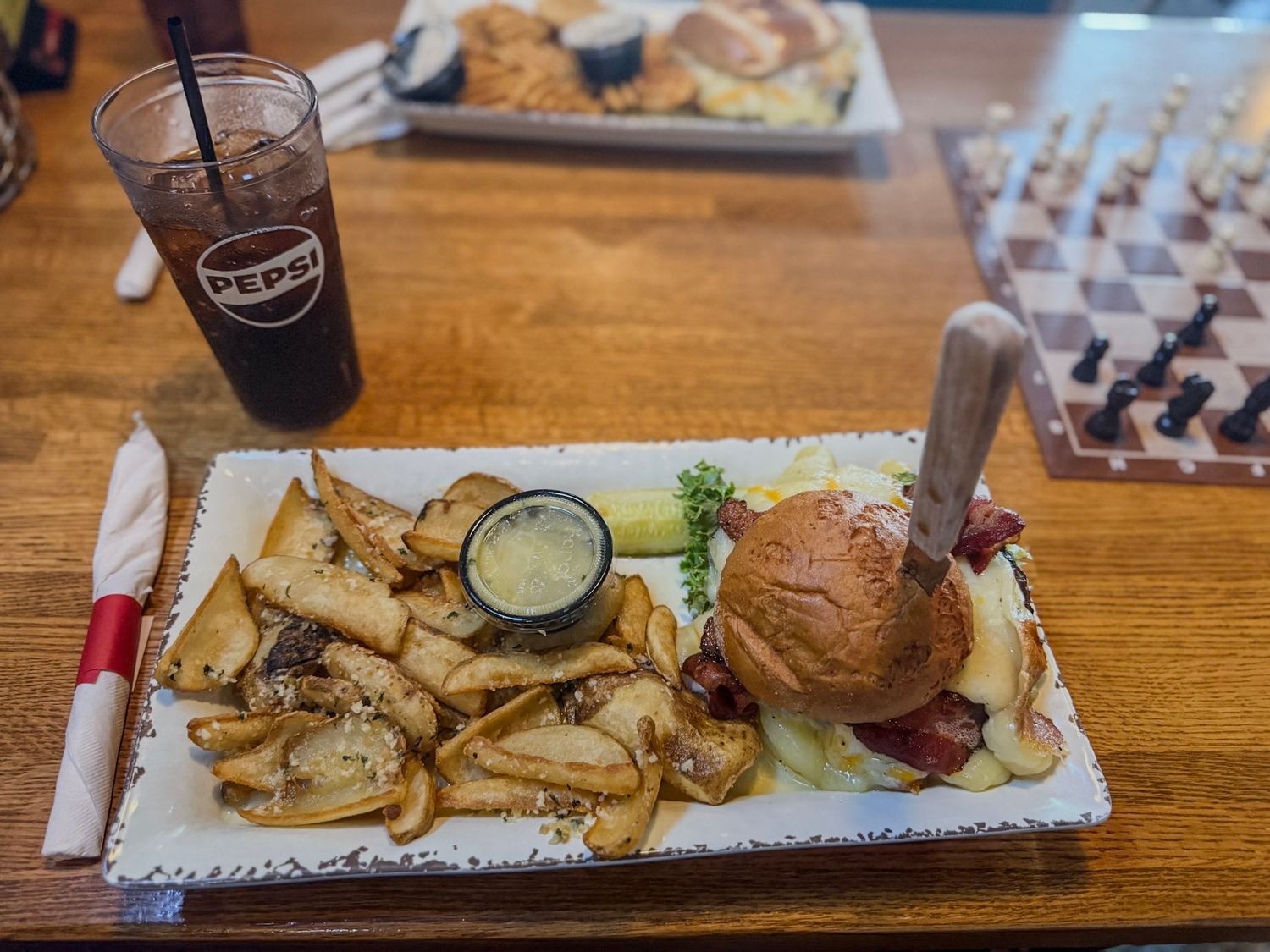 Appetizer platter with various snacks served on wooden table.