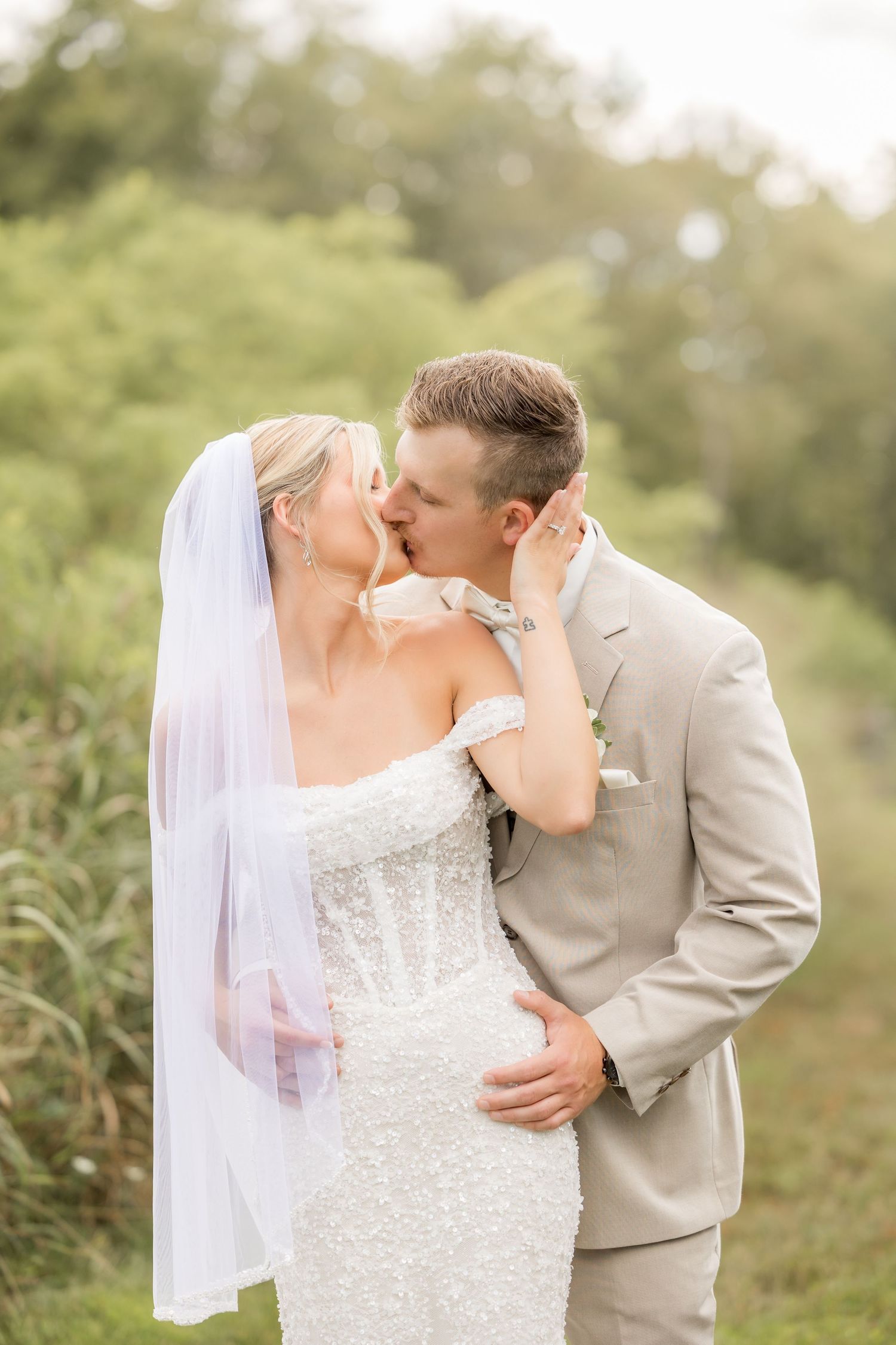 A romantic wedding couple embraces in an outdoor garden photo taken Edward Jacob photography in Johnstown pa