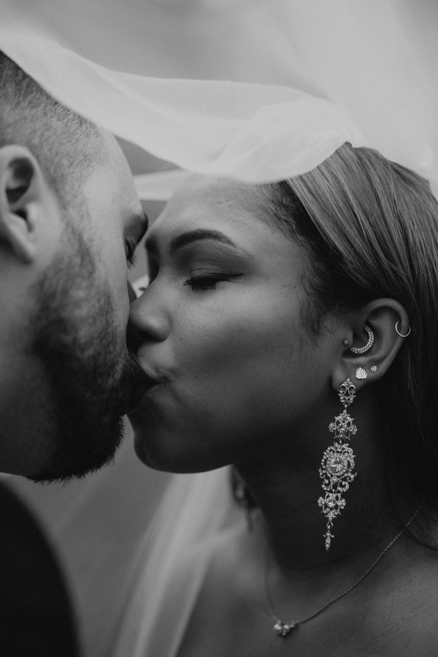 Husband and wife kissing in Belllevue Washington for their wedding day.