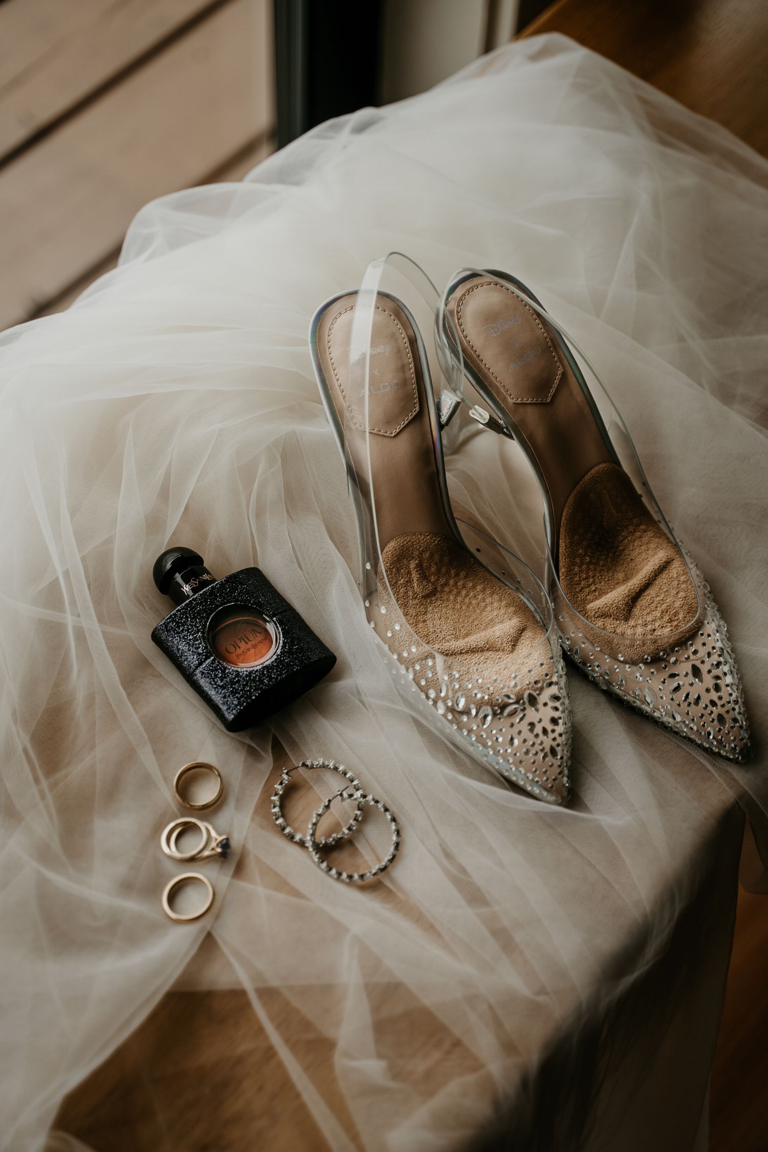 Flay lay of a brides shoes, jewelry, vail, perfume and other accessories in Seattle, Washington. Wedding photography in Seattle.
