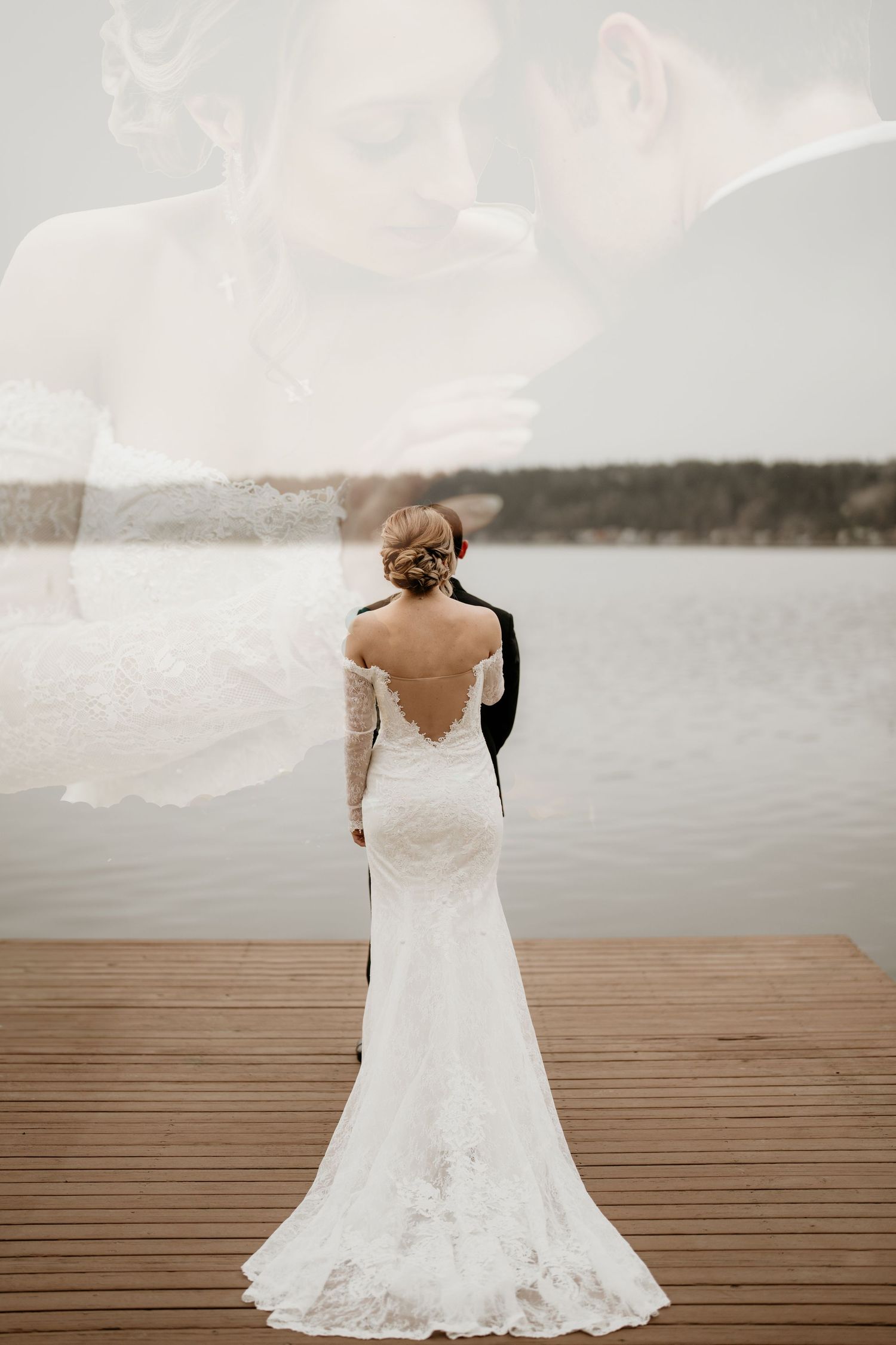 Bride stands behind groom on the dock for first look in their wedding outfit in Seattle, Washington before they get married.