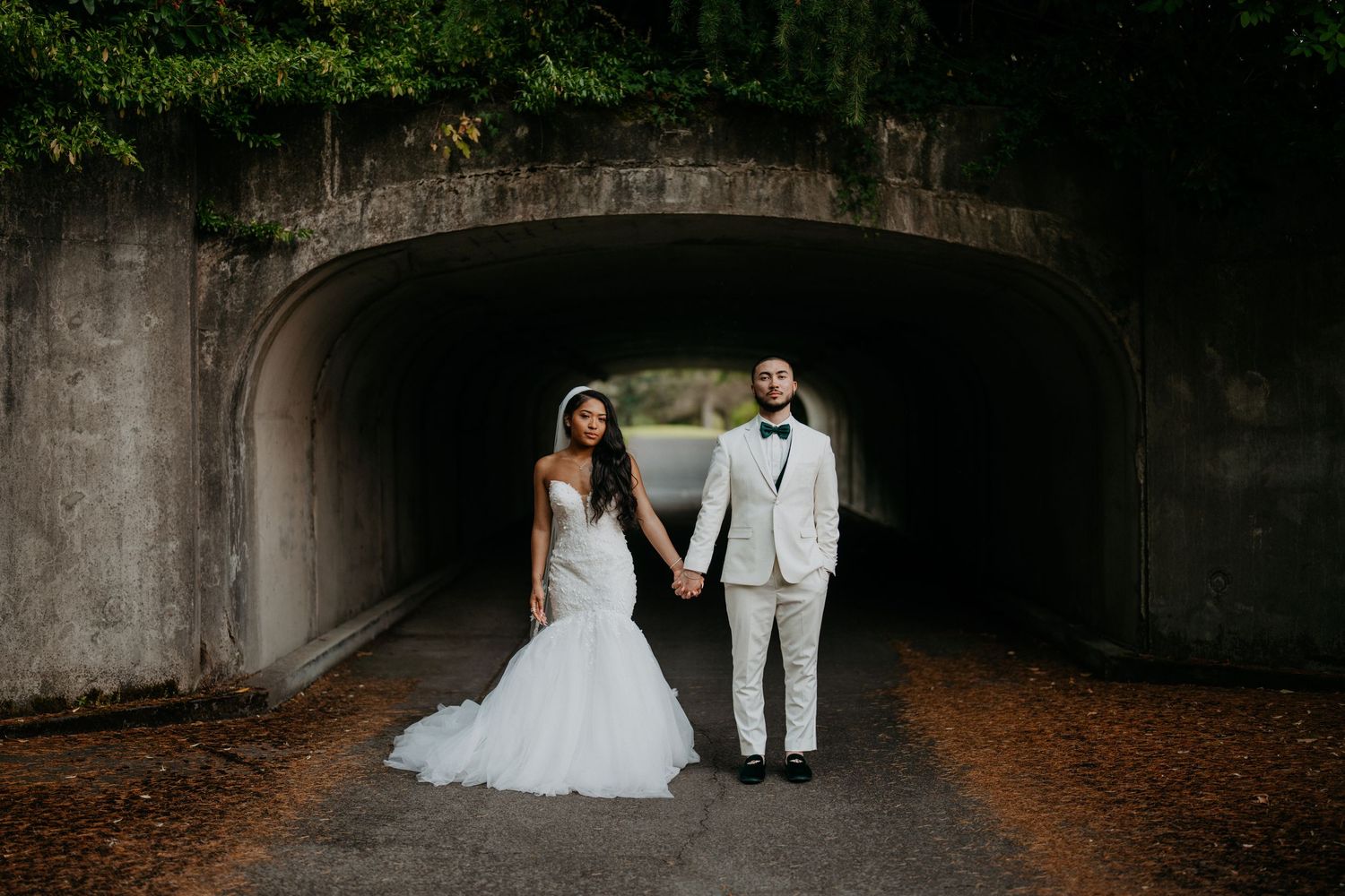 Husband and wife standing in front of a tunnel at a golf course in Olympia Washington