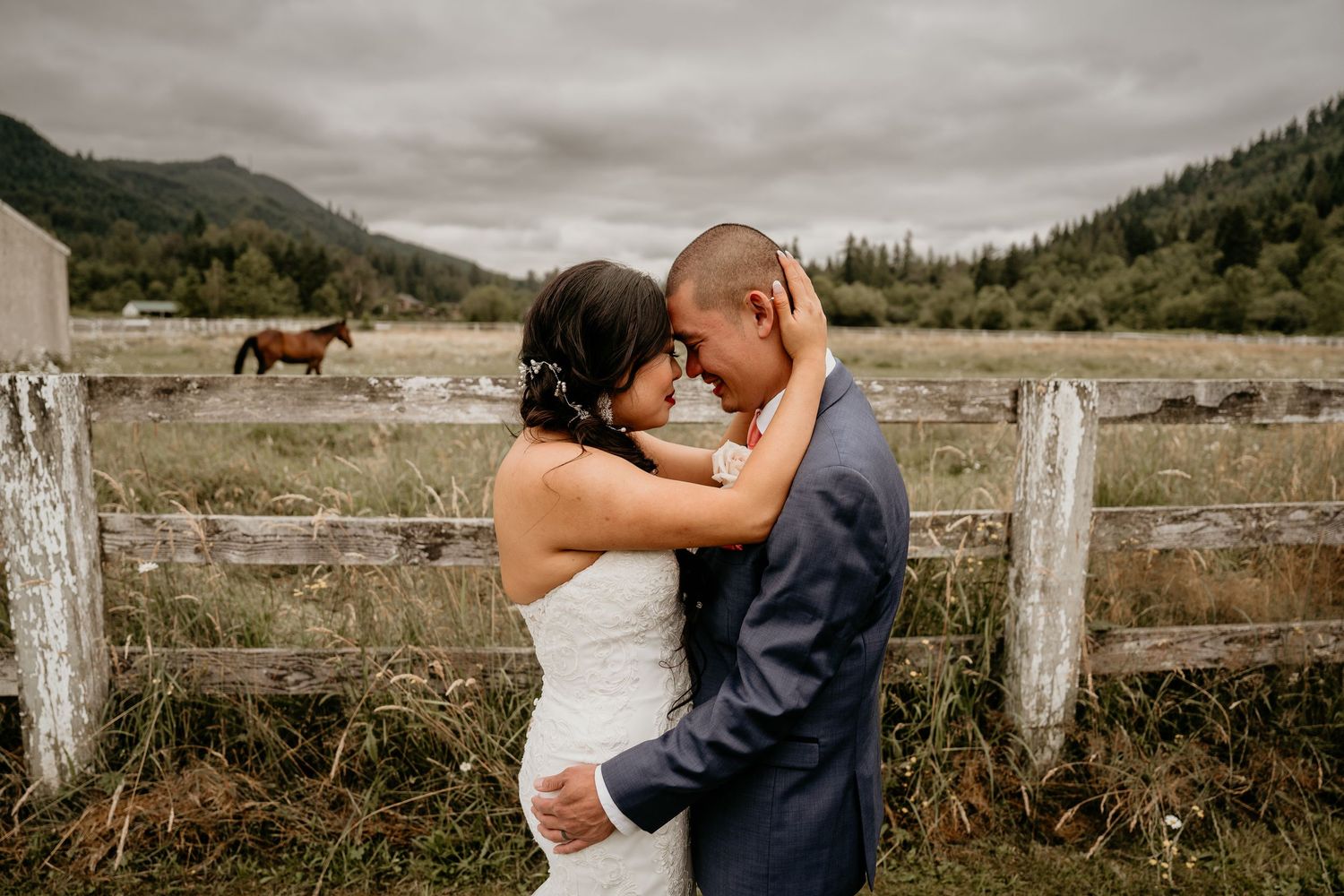 Husband and wife holding eachother at Rein Fire Ranch on their wedding in Black Diamond Washington