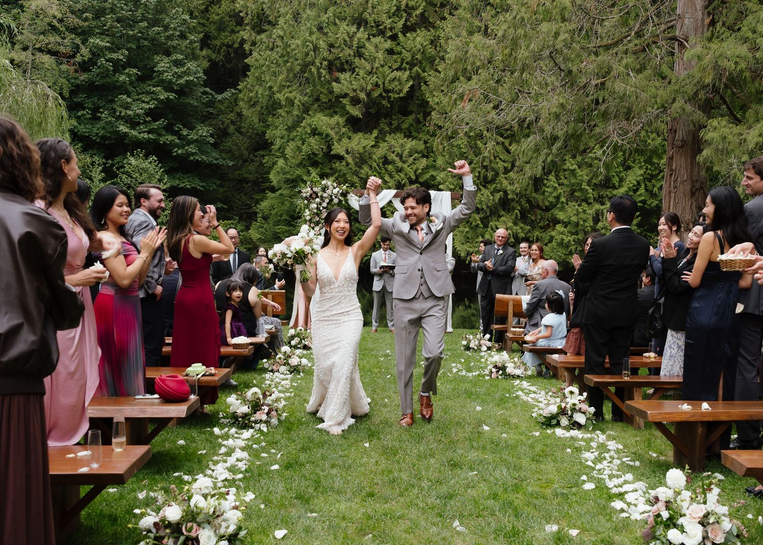 Husband and wife getting married at the Cedars in snohomish, wa. Celebrating after they just kissed as husband and wife.
