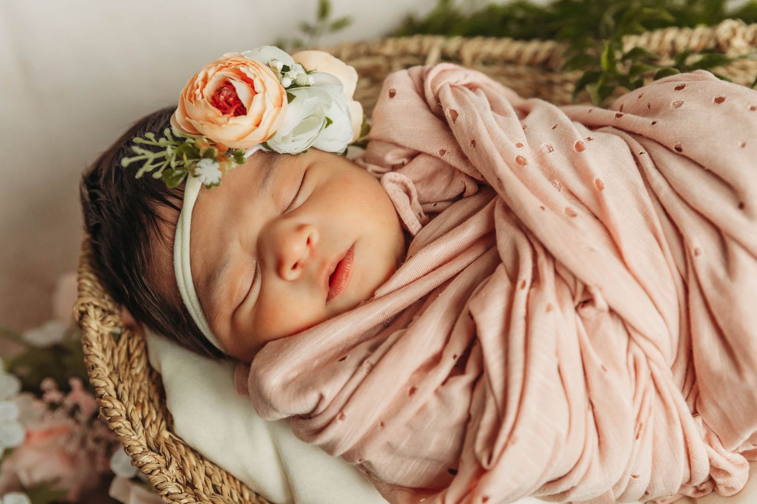 Photography - Newborn wrapped in pink, flowers and boho baskets.