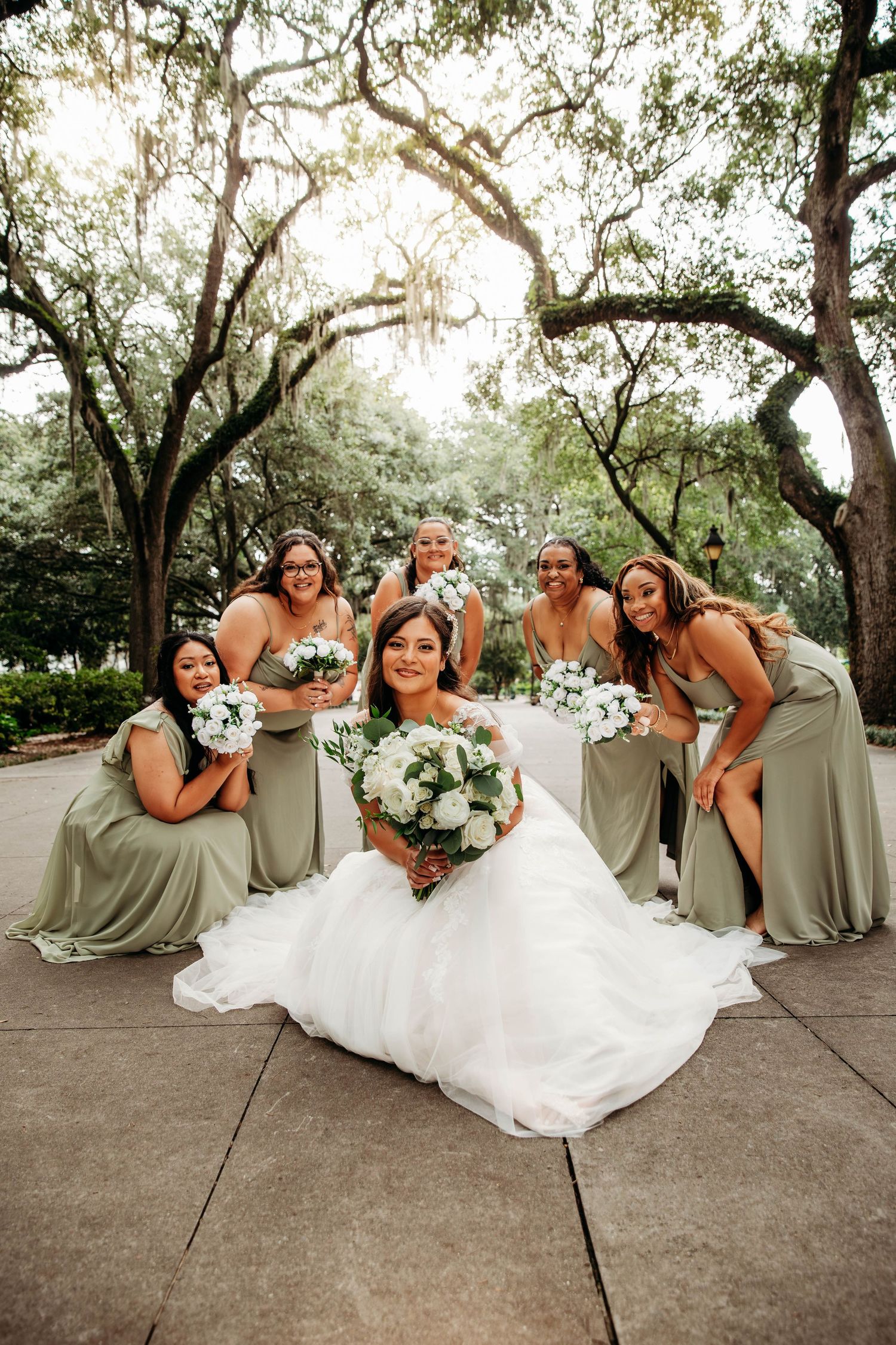 Fun bridesmaids and bride portrait by L. Ballenger Photography, a top-rated wedding photographer in Branson MO.
