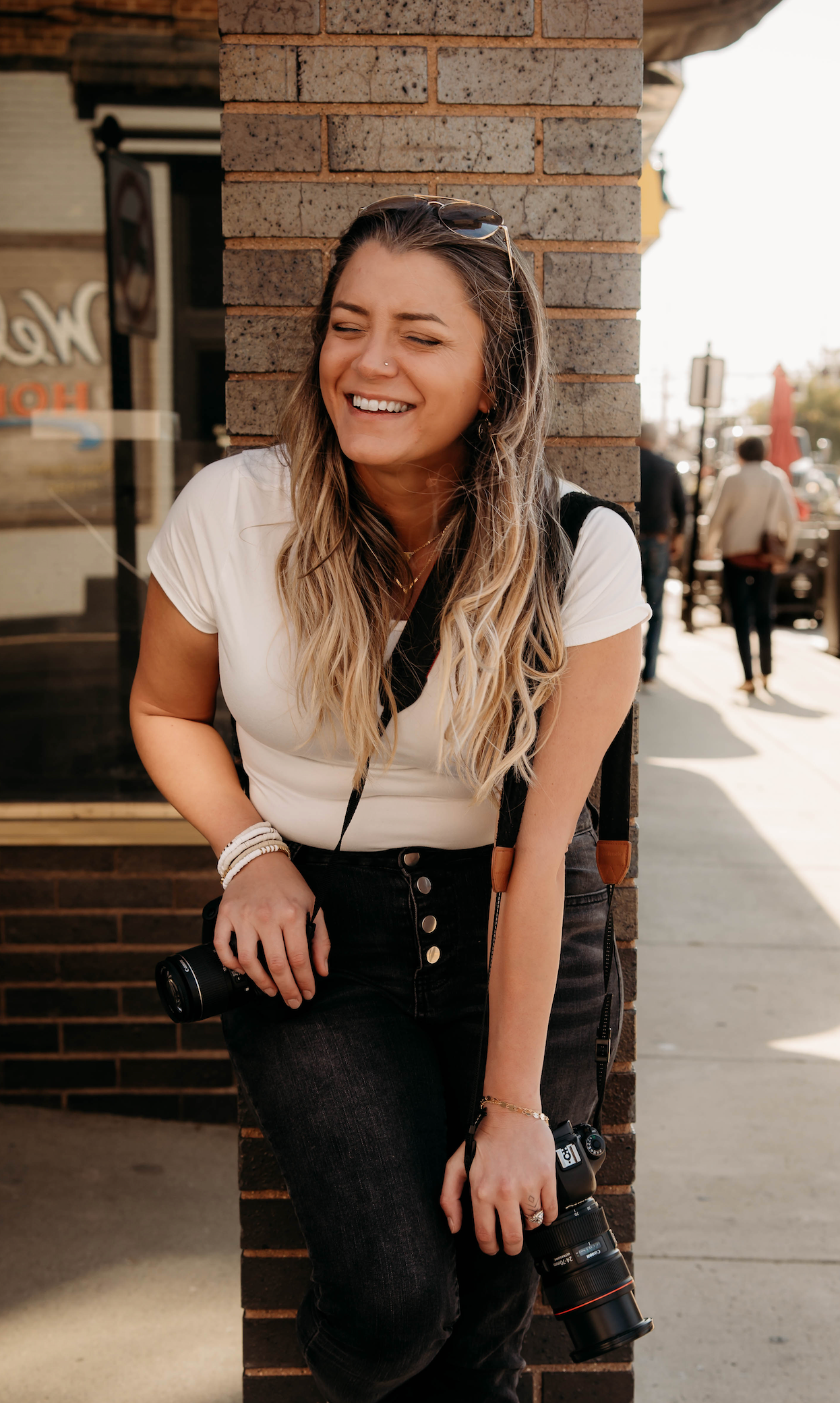 Lifestyle Branson, MO Photographer L. Ballenger smiling during an urban outdoor photo session in Missouri.