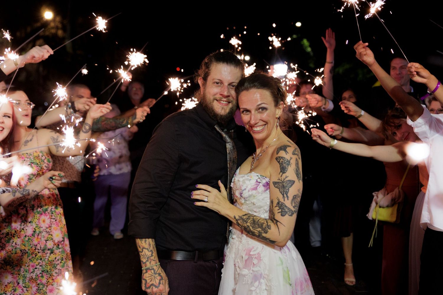 Bride and Groom surrounded by their friends with Sparklers