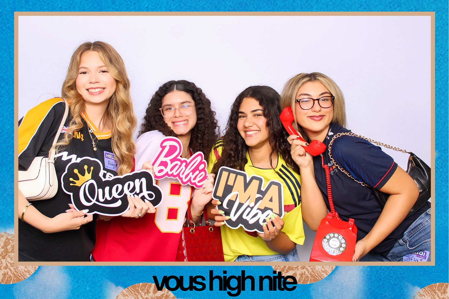 A group of friends pose together for festive holiday party photos against a bright blue background.