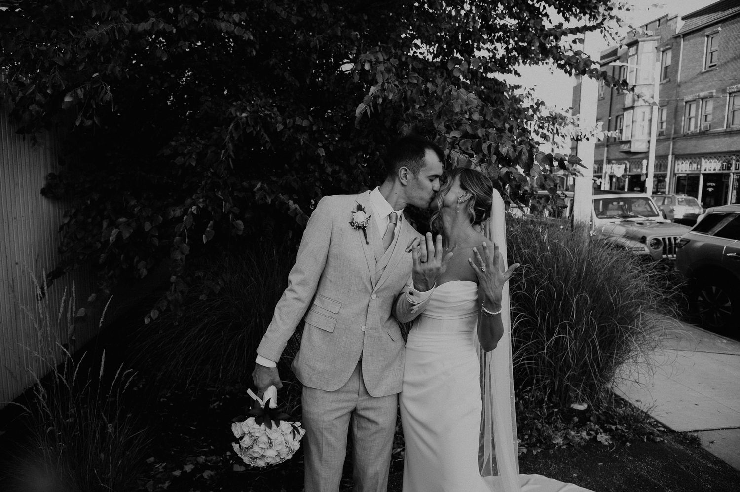 A romantic black and white wedding photo collage showing tender moments between newlyweds outdoors.