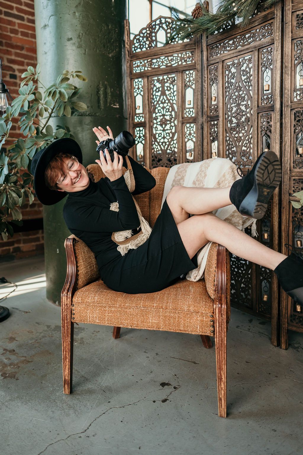 A person in black clothing performs a dramatic falling sequence on an ornate vintage wooden bench with carved details.