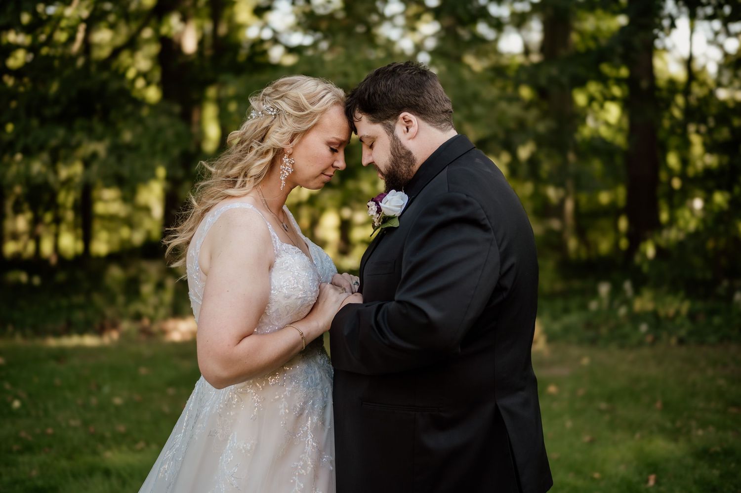 An intimate wedding portrait of a couple sharing a tender moment in formal attire in NE Ohio.