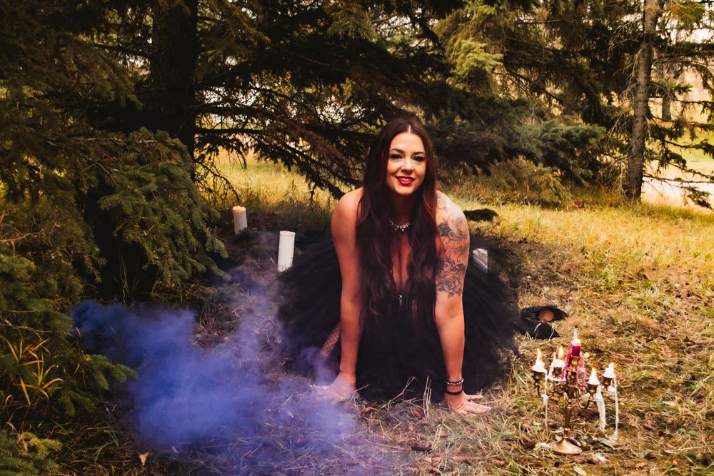 Artistic outdoor photo with purple smoke effects in wooded setting.