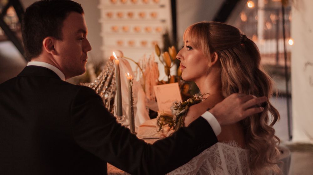 Romantic candlelit moment at an elegant wedding reception.