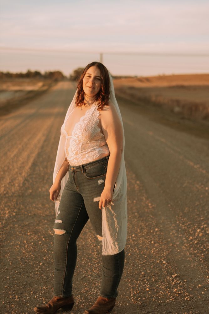Candid portrait on rustic dirt road during golden hour.