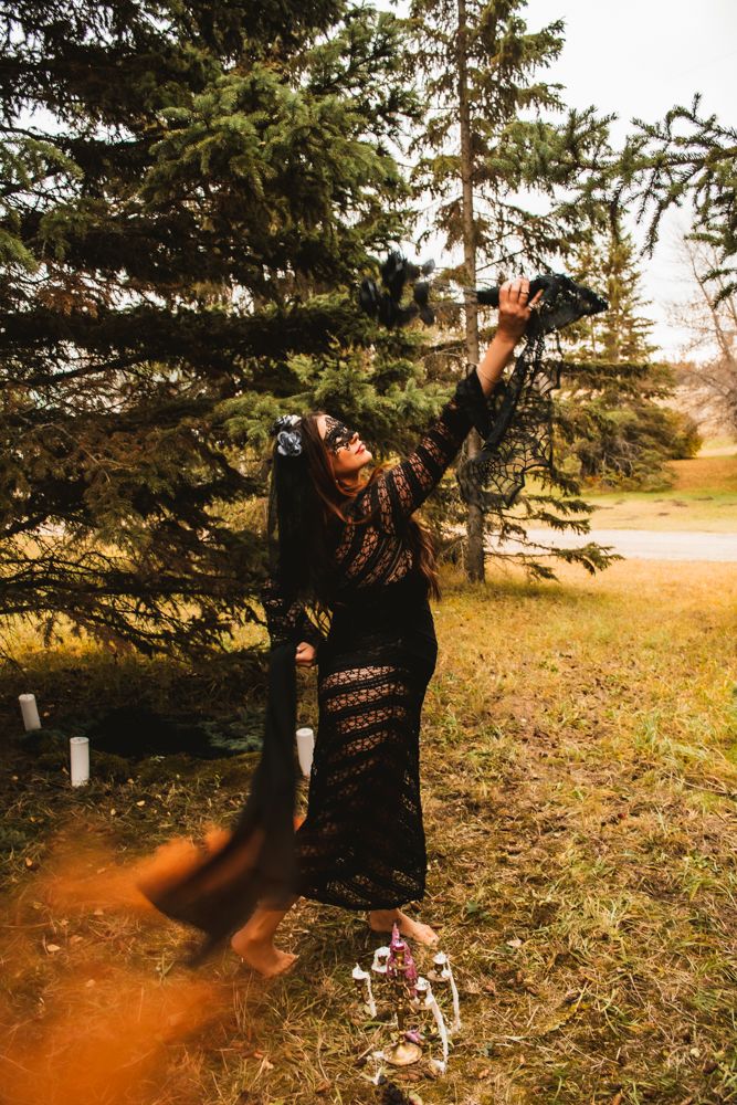 Ethereal forest scene with lace-clad figure reaching skyward through orange smoke.