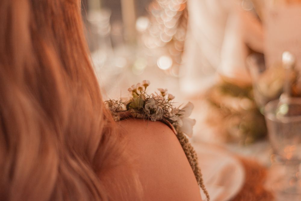 Close-up of delicate floral crown with dried flowers and greenery.