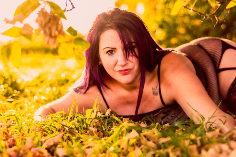 Intimate outdoor portrait with soft natural lighting and fall foliage.