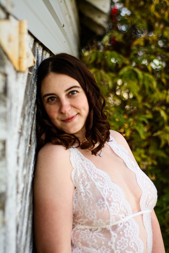 A romantic portrait featuring white lace against rustic wooden backdrop.