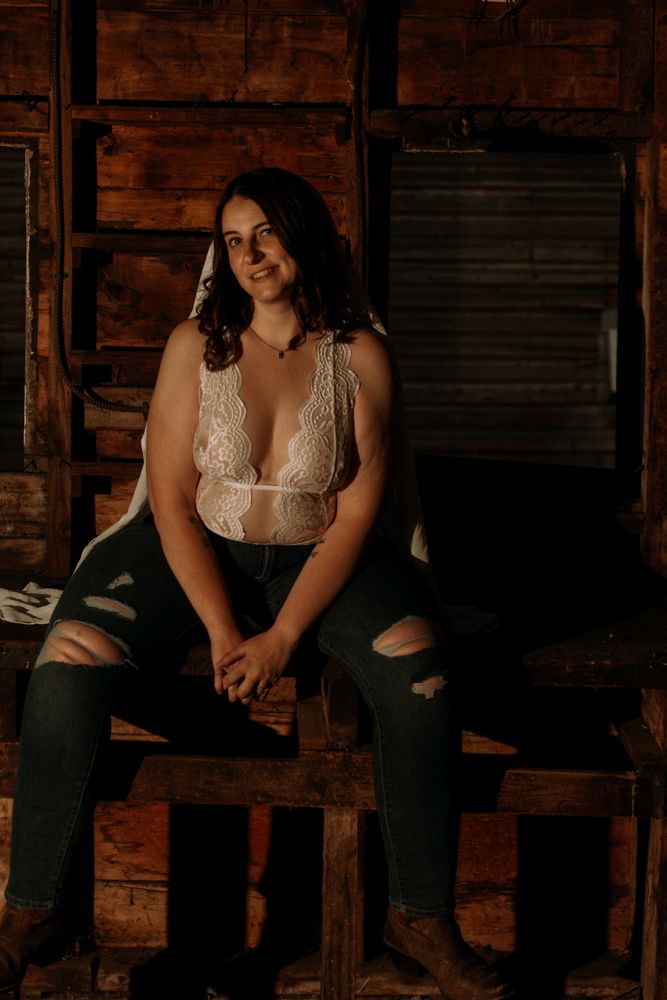 Fashion portrait in a rustic wooden setting with natural window light.