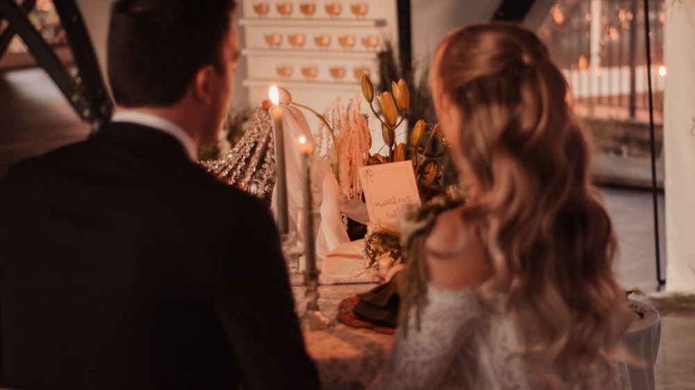 Romantic candlelit table setting with elegant decor and glowing ambiance.