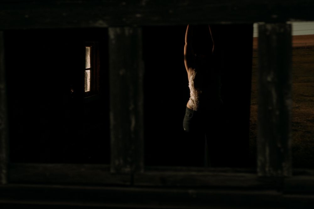 Minimalist silhouette photographed through dark architectural framing.