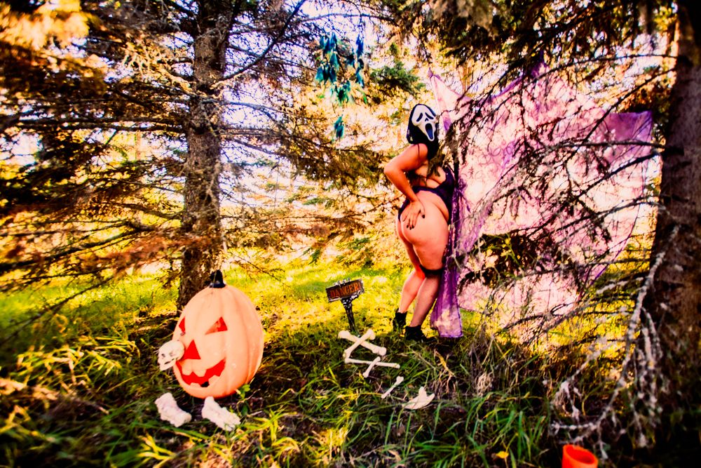 Haunted forest scene with jack-o-lantern and Halloween decorations in golden afternoon light.