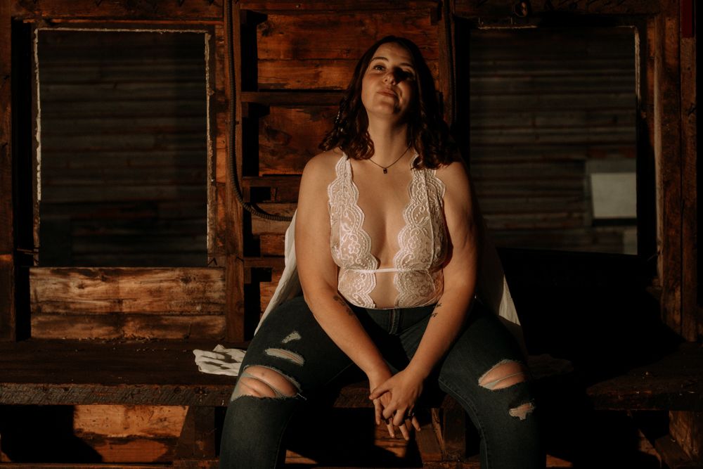 Intimate portrait session in a rustic wooden interior with natural lighting.