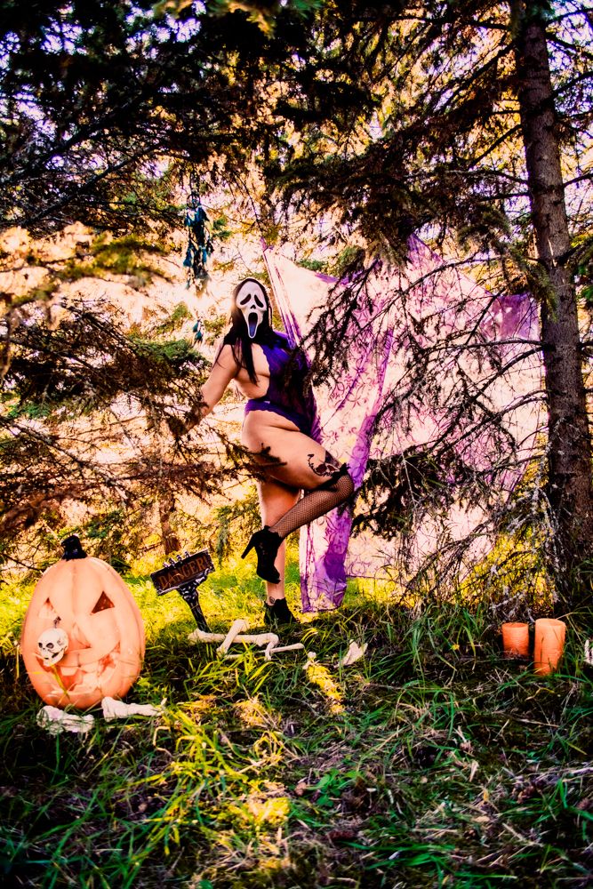 Atmospheric Halloween display with carved pumpkin and gothic elements in a misty forest setting.