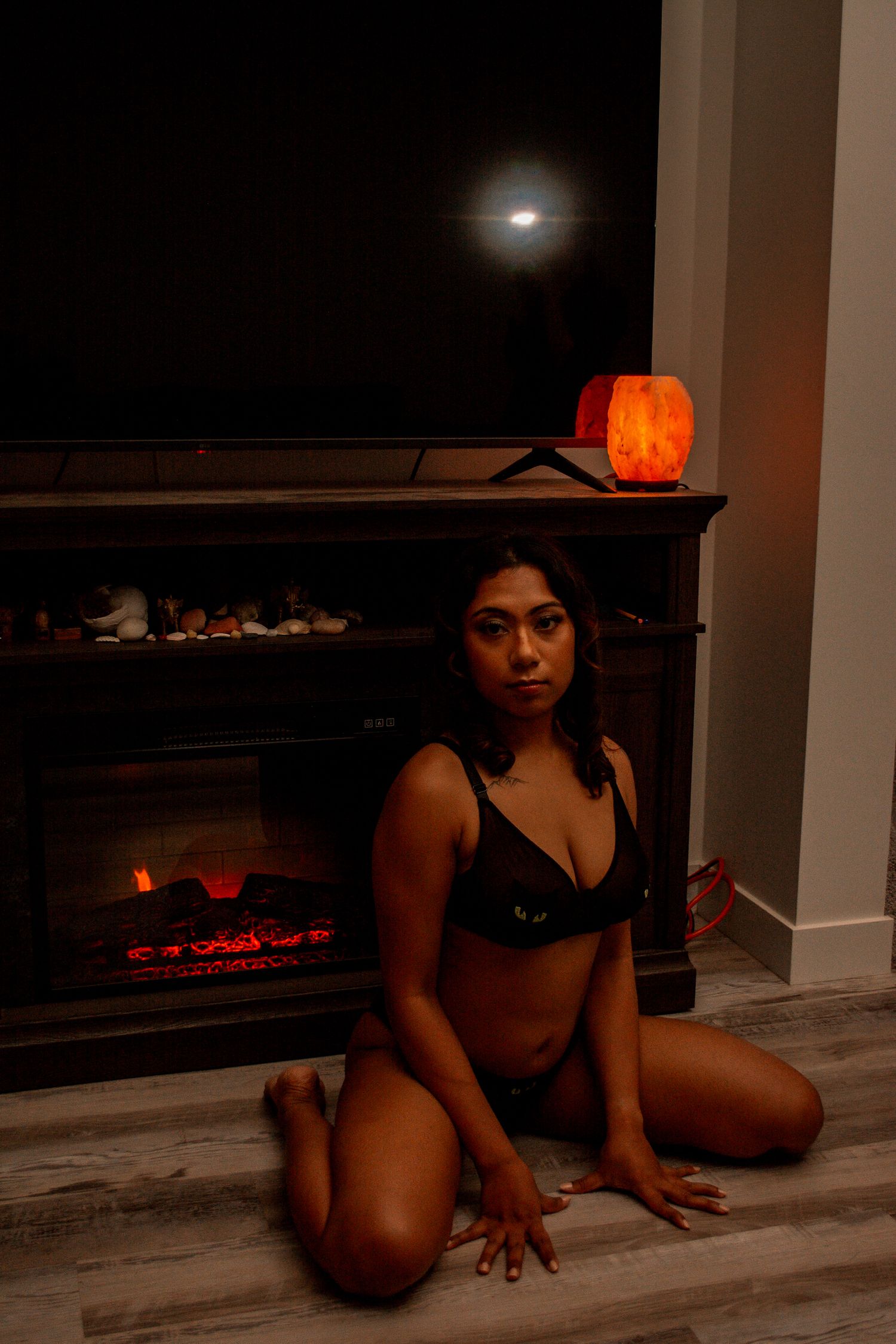 Low-key portrait with moonlight and orange lantern creating mysterious ambiance.