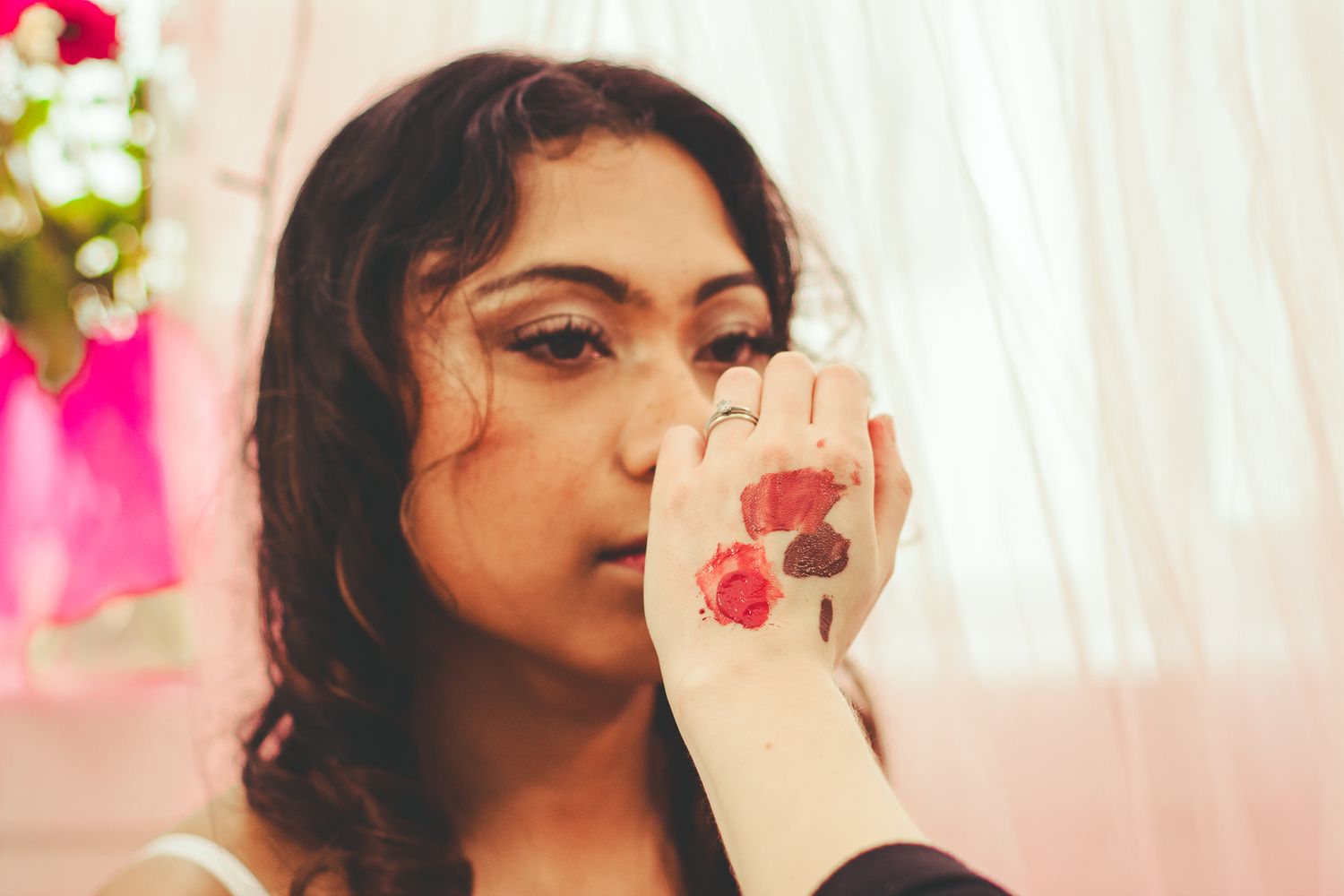 Makeup artist applying cosmetics during a professional beauty session.