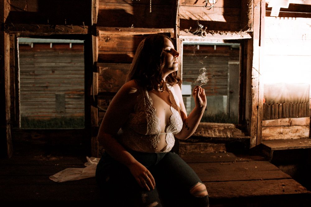 Artistic portrait in an old wooden room with sunlit windows.