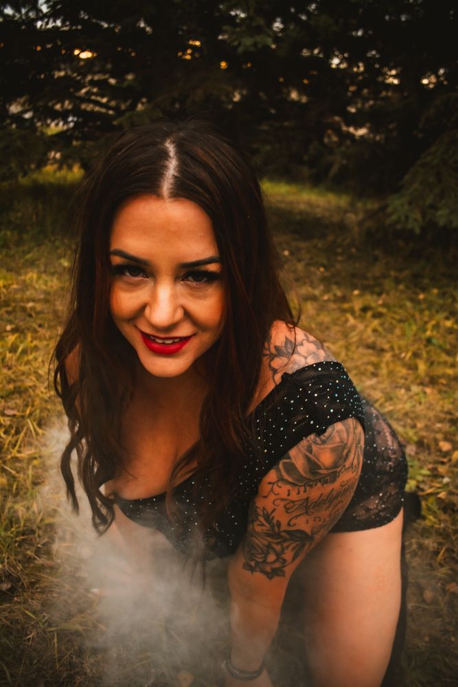 Fashion portrait with smoke effects and natural forest backdrop.