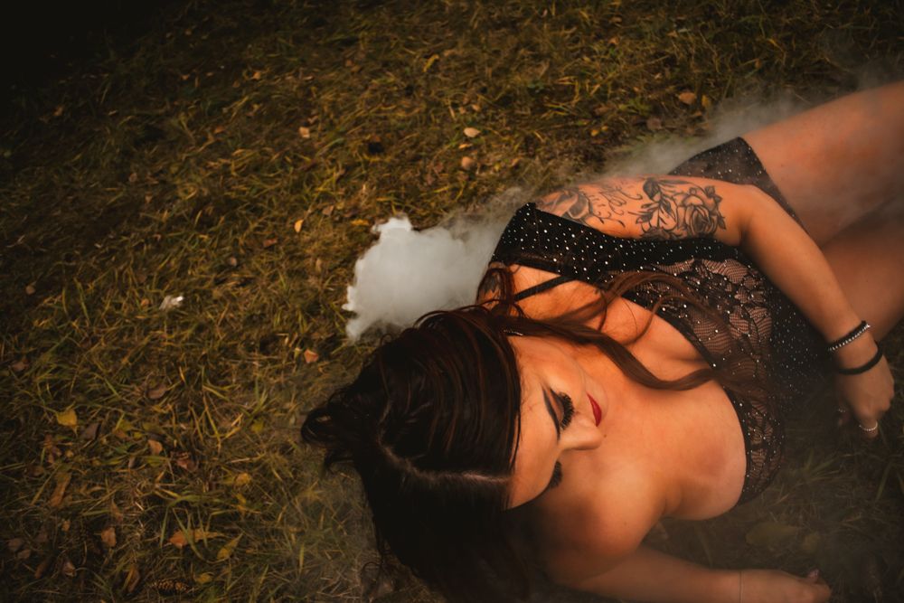 Dramatic overhead portrait with smoke effects on autumn ground.